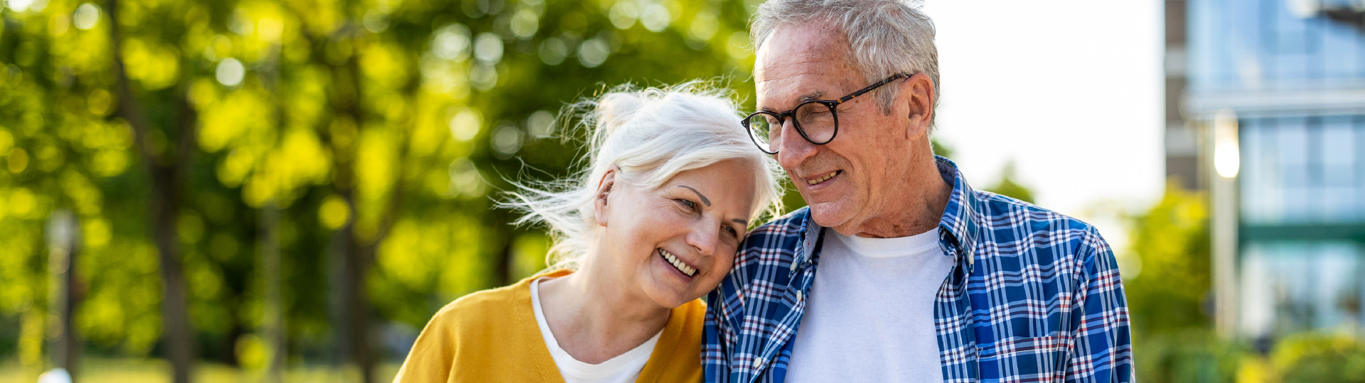 A senior man and woman walk with one another