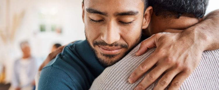 A man gives a senior a hug