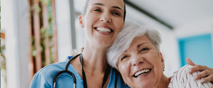 A nurse and woman huge one another